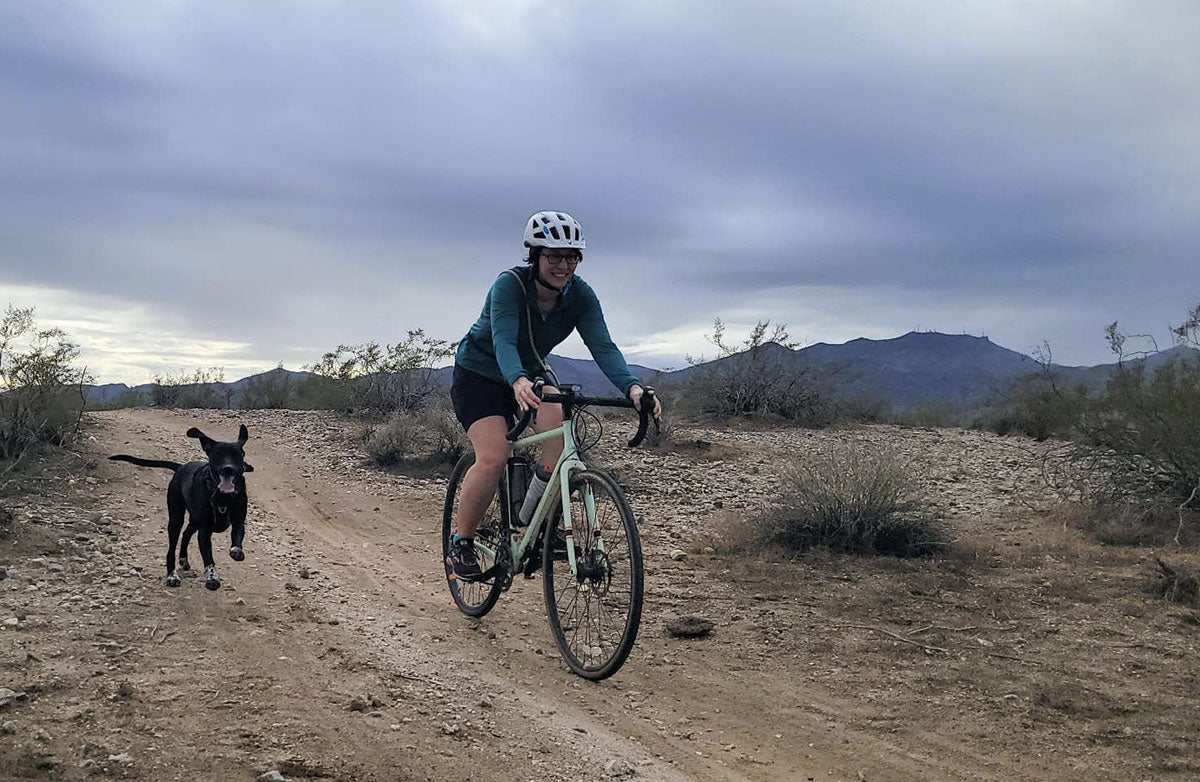 Ash and Meg ride together, smiling at the camera.