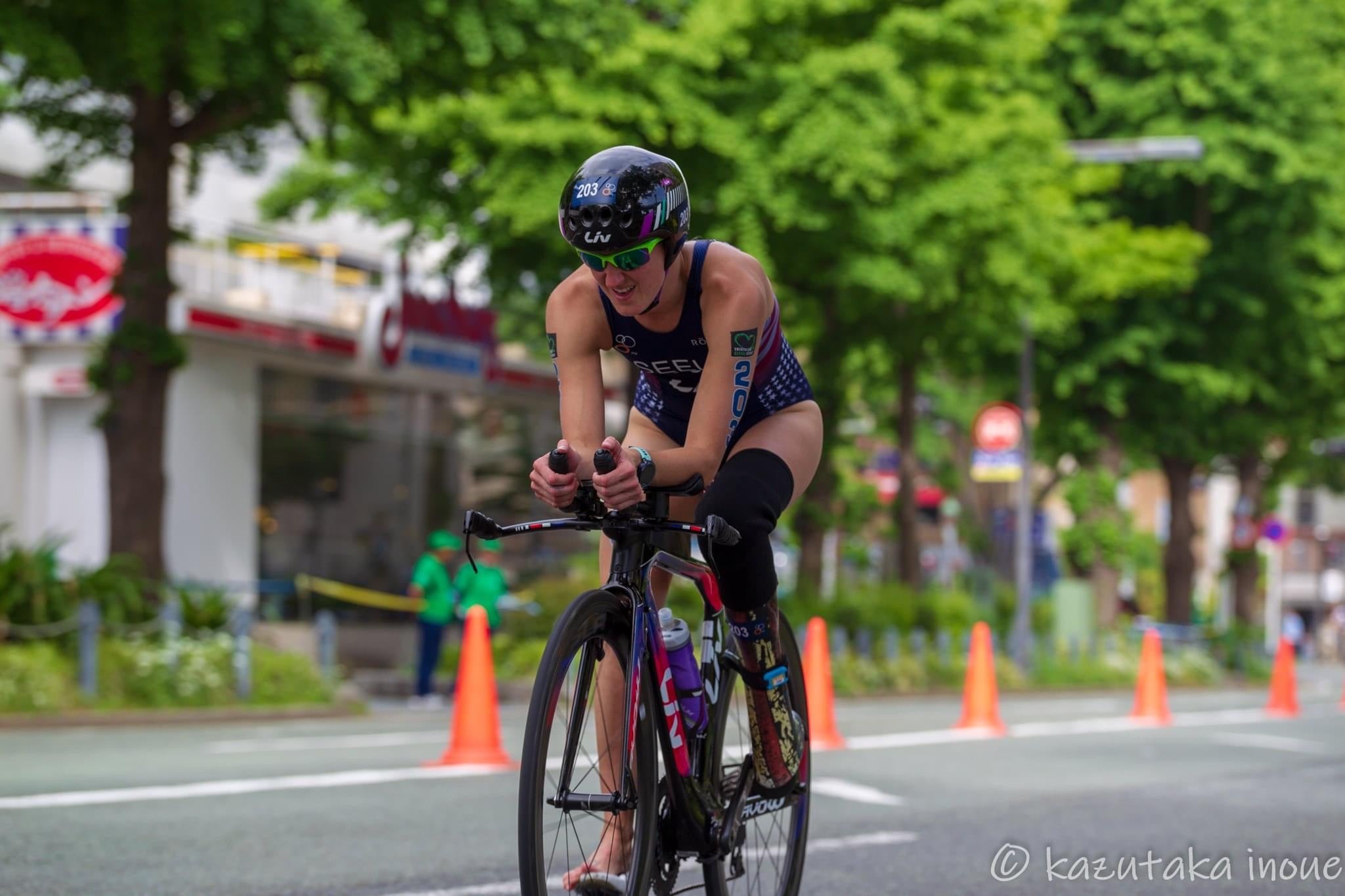 Paralympian Gold Medalist Allysa Seely rides a bike during a triathlon race. 