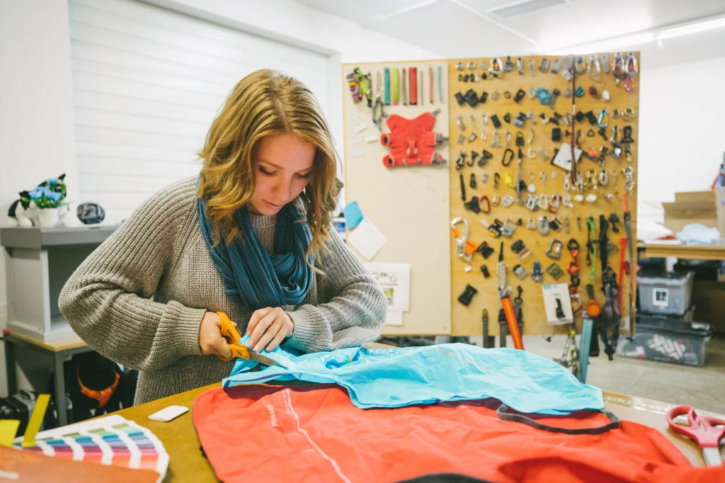 Product Developer Liz cuts fabric in the Ruffwear studio.