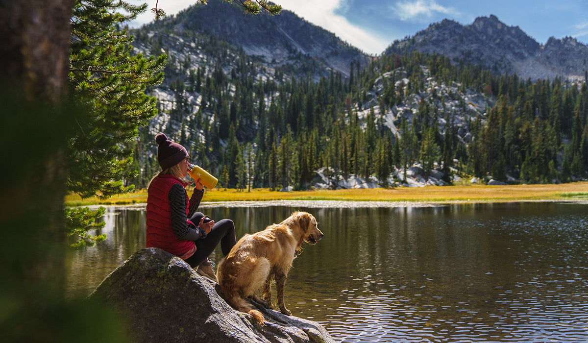 dani and ranger sit by a lake