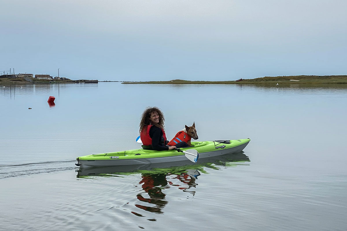 Raya and Grimlock float on the Arctic Ocean in their kayak.