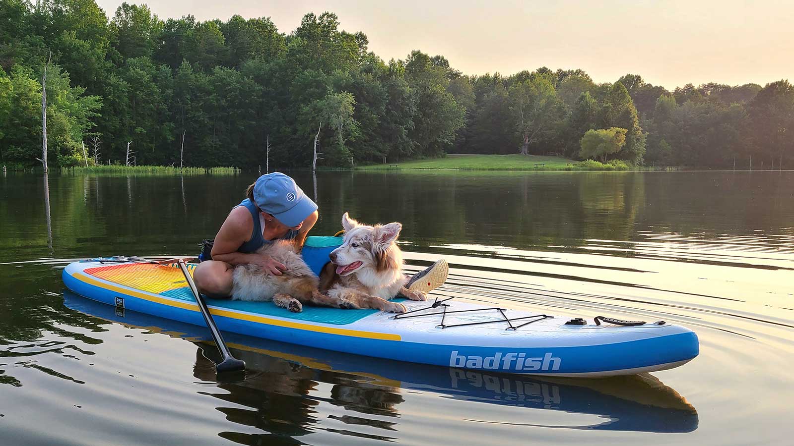 Maria and Ripley share a snuggle on a paddle board