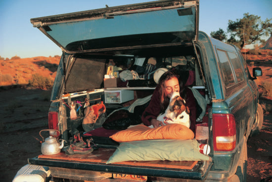 Steph and her dog in the back of a truck.