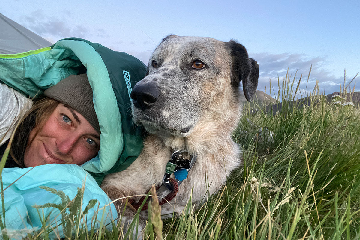 Indy and Julianne lay in the grass together.