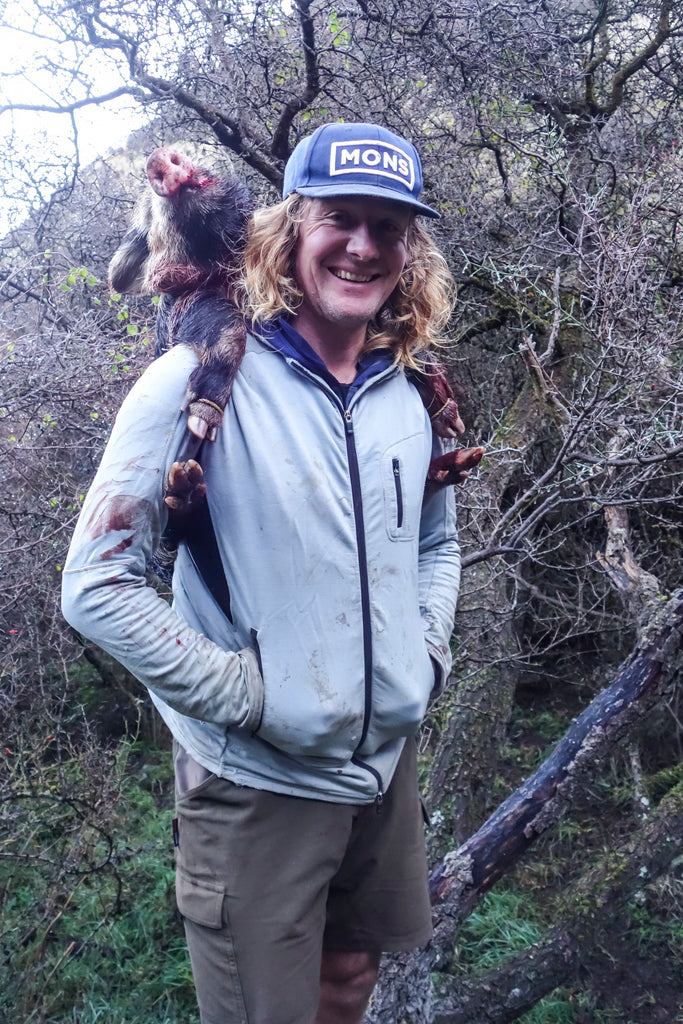 Angus Rowley carrying a pig