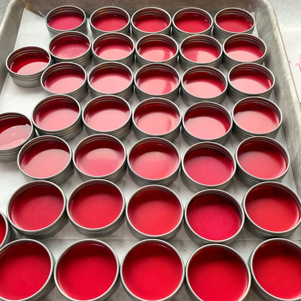 Magenta lip tints being filled at the Sea Witch Botanicals lab