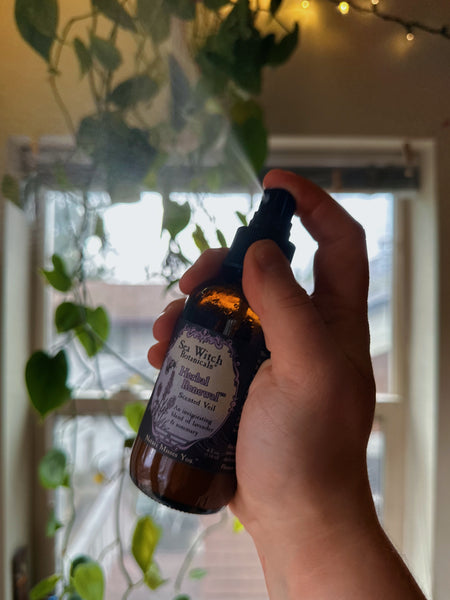 Herbal Renewal veil spritz with a window and hanging plant in the background.