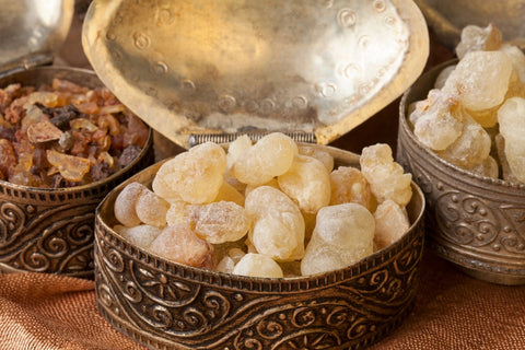 Closeup of Frankincense resin pearls in ornate dish with other resins in background