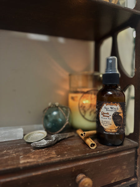 Various witchy objects arranged on a wooden shelf.