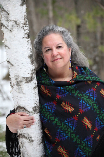 Photo of Robin Wall Kimmerer with a tree.