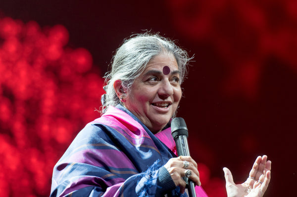 Photo of Vandana Shiva speaking at a conference in Germany.