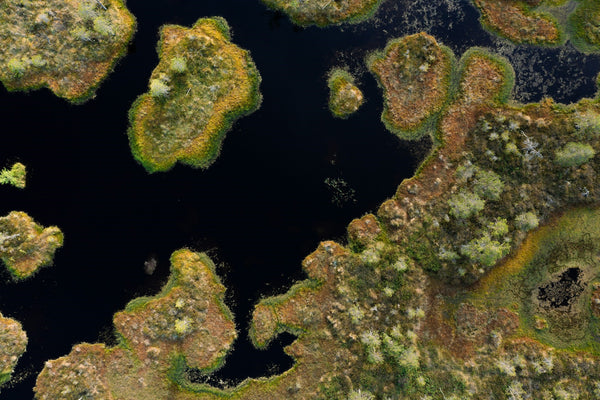 an aerial shot of a body of water surrounded by land