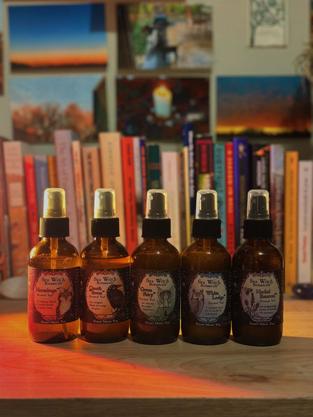 Lineup of scented veils on a desk with books and photos in the background.