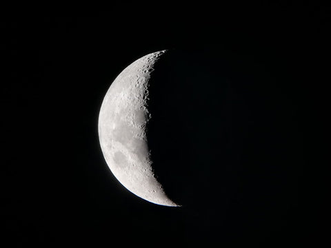 Waning Crescent moon on dark background