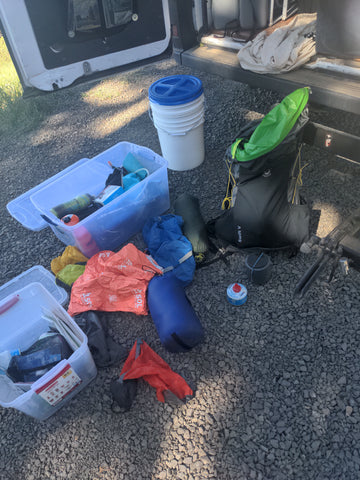 a pile of gear getting ready to be packed into a vehicle