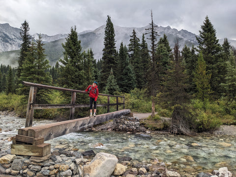 Heather crossing a bridge over a creek