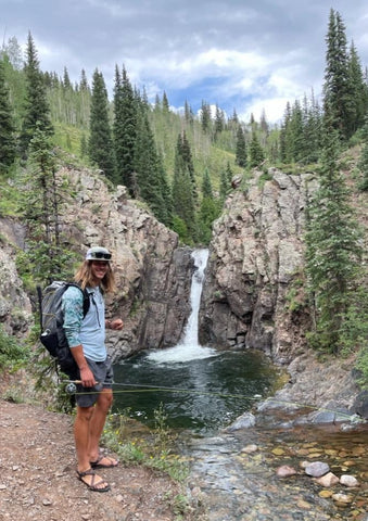 Oliver standing next to a creek.