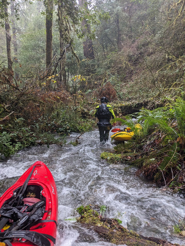 getting ready to carry the boats over a log jam on the creek