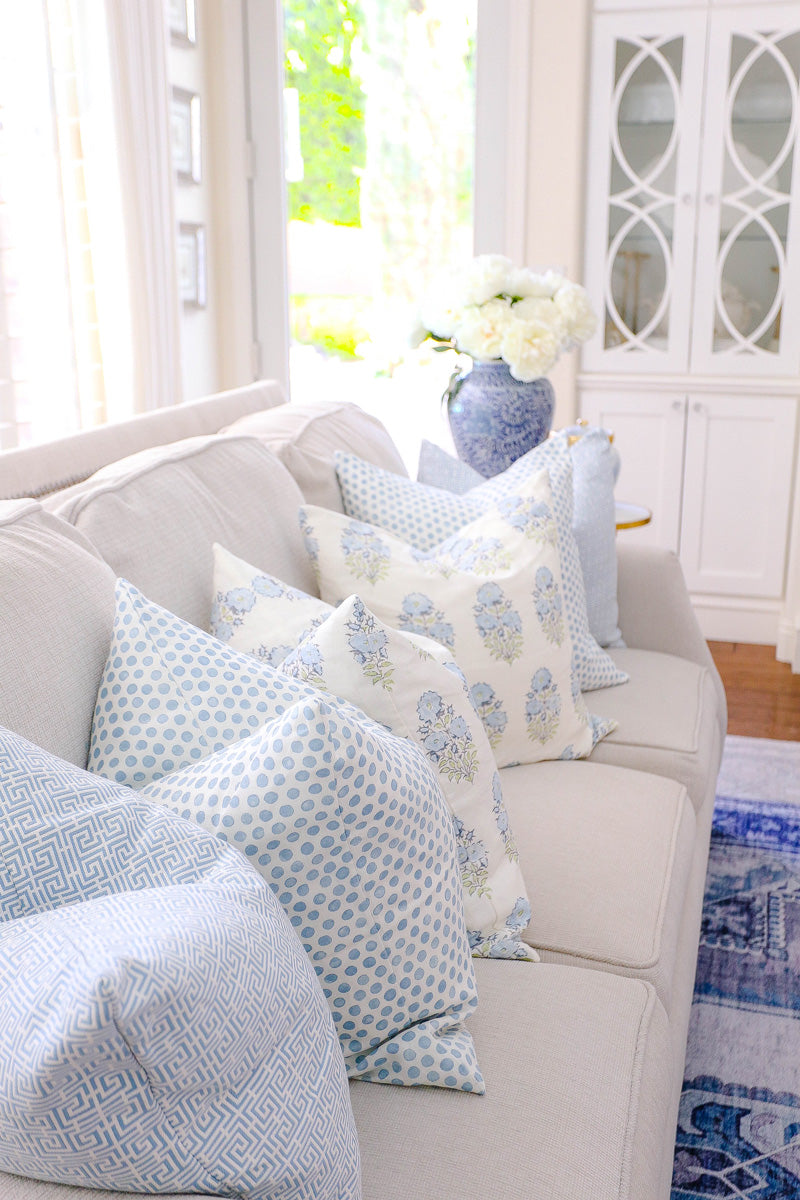 Blue and white patterned designer pillows on beige sofa from Arianna Belle Shop |  living room of Randi Garrett