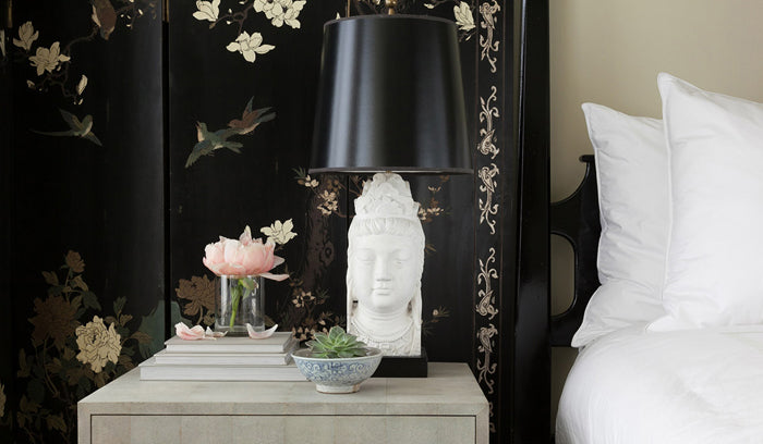 bedroom with Buddha lamp, white bedding and ornate black wallpaper | interior design by Grant K. Gibson