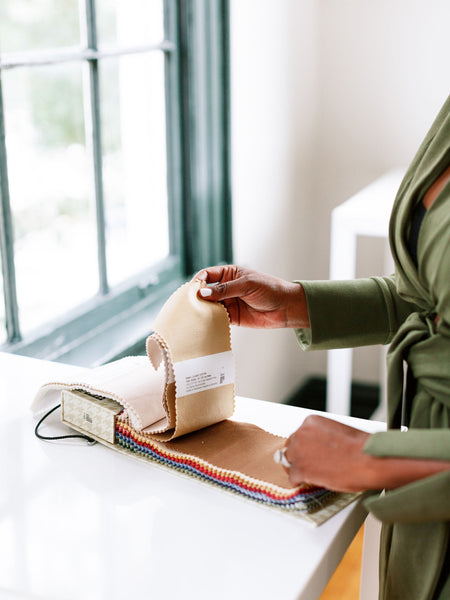 designer choosing fabric for pillows