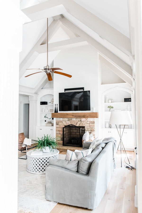 Designer Spotlight: Kate + Amanda | Arianna Belle Blog | living room with high ceilings fireplace and cozy grey sofas