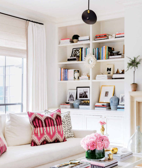 living room with Bukhara Ikat Fuchsia pink pillows | interior design by Paloma Contreras