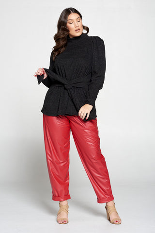 livd plus size boutique plus size girl wearing black wrap sweater top and red faux leather pants