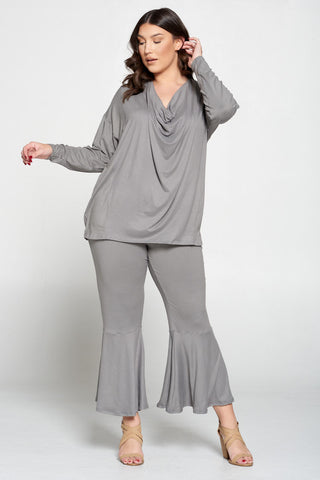 plus size clothing store livd. model wearing two piece comfortable set with draped top and flare pants