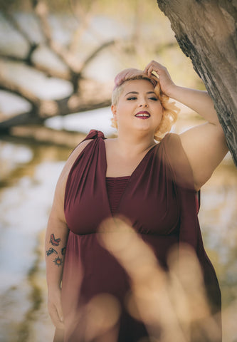 Plus Size woman wearing the Henkaa Daffodil Convertible Dress in Burgundy Wine.