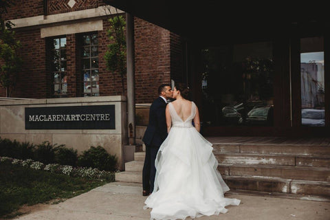 Jacqueline Sbeyti and Ayad Sbeyti share a kiss outside their wedding venue.