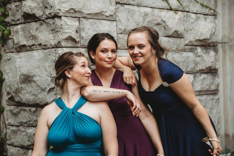 Bridesmaids pose wearing Henkaa Sakura Convertible Maxi Dresses in the colours Turquoise Teal, Plum Purple and Navy Blue.