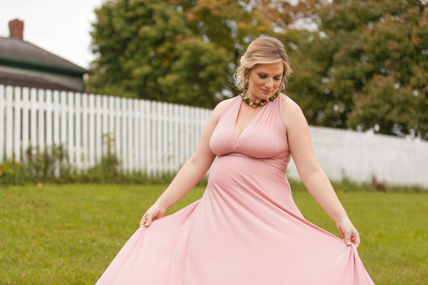 Pregnant woman wearing the Henkaa Dusty Rose Infinity Dress