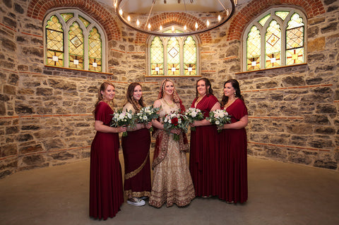 Stephanie Rochefort poses alongside her bridal party who are wearing Henkaa Burgundy Wine Sakura Maxi Infinity Dresses.