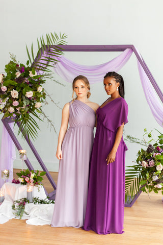 Two diverse models wearing Henkaa Daffodil Convertible Lace and Chiffon Dress in Dusty Purple and Plum Purple as bridesmaid dresses.