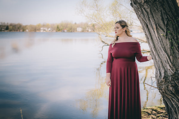 Blonde woman wearing Iris Burgundy Wine Iris Maxi Dress. 