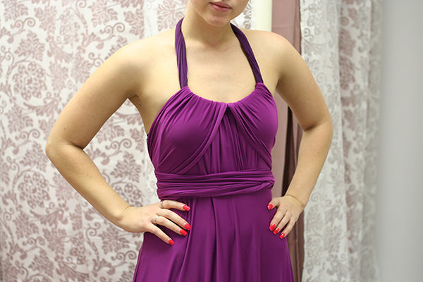 How to wear a sash: woman wearing a magenta purple dress and a sash as a halter strap.