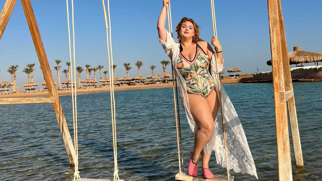 Lia combines comfort and style with her beach caftan and Clara swimsuit combo.