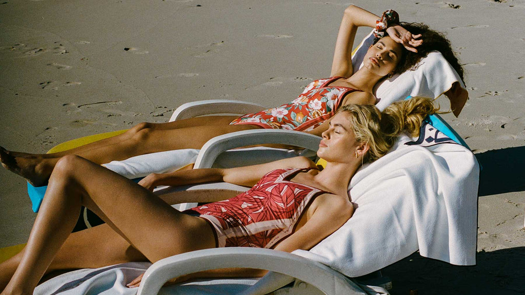 Two girls wearing reversible one piece swimsuits from Antique Paradise collection