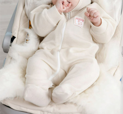 Baby in Ruskovilla wool baby sleep and play bodysuit with feet