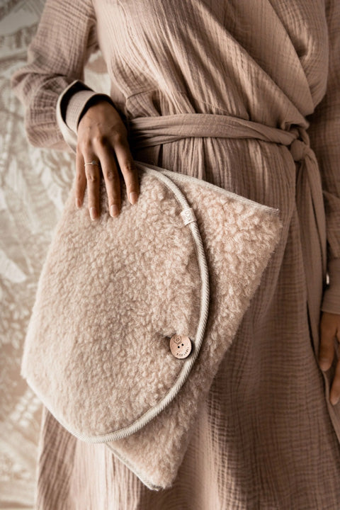 woman holding a baby changing mat