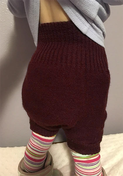Disana wool pull on bordeaux on a baby