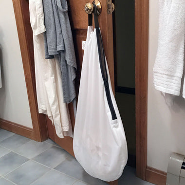 white bum genius hangout wet bag in a bathroom diaper storage