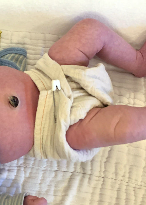 how to use a newborn muslin flat with diaper pins