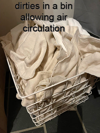 storing dirity kitchen cloths in a bin