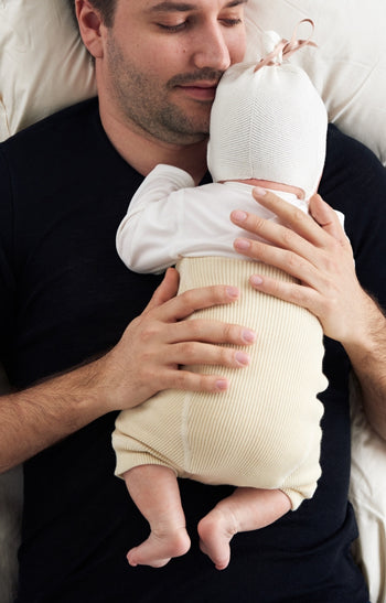 dad holding baby in wool diaper cover