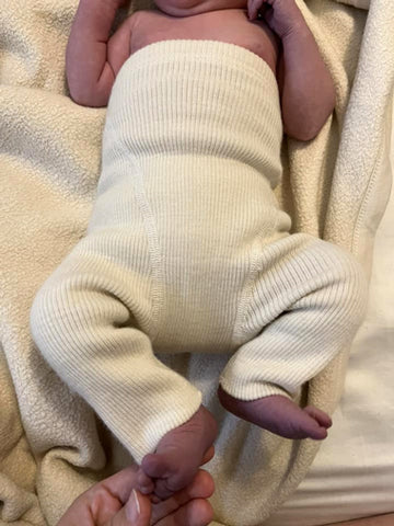 Ruskovilla long legs wool cover on a newborn baby size 50