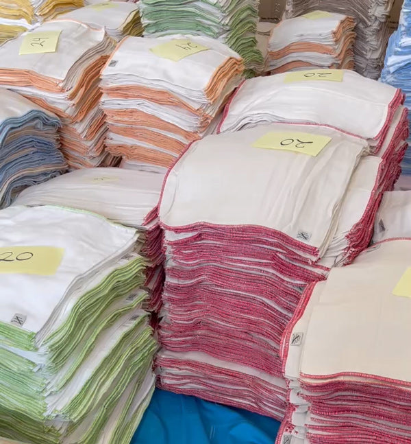 seconds piles of prefold cloth diapers