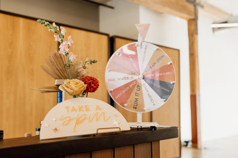 Spin the wheel drink game at wedding reception bar