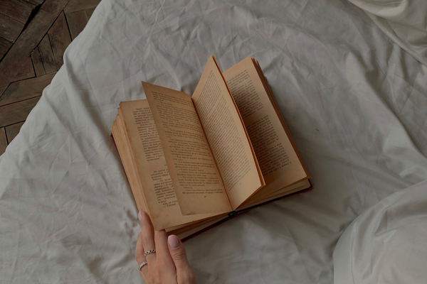 book on white bed